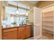 Kitchen with breakfast bar featuring granite countertops, stainless steel appliances, and walk in pantry at 11500 E Cochise Dr # 2088, Scottsdale, AZ 85259