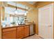 Kitchen with breakfast bar featuring granite countertops, stainless steel appliances, and a view to the patio at 11500 E Cochise Dr # 2088, Scottsdale, AZ 85259