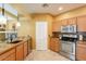 Charming kitchen with wooden cabinets, stainless steel appliances, and tile backsplash at 11500 E Cochise Dr # 2088, Scottsdale, AZ 85259
