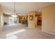 Spacious living room features a fireplace, built-in shelving, and sliding glass doors to the balcony at 11500 E Cochise Dr # 2088, Scottsdale, AZ 85259