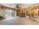 Open-concept living room with balcony access, a fireplace, and a breakfast bar at 11500 E Cochise Dr # 2088, Scottsdale, AZ 85259