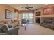 Inviting living room features a stone fireplace, comfortable seating, and sliding glass doors to a patio at 11500 E Cochise Dr # 2088, Scottsdale, AZ 85259