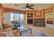 Comfortable living room with fireplace, media center, and access to outdoor seating with mountain views at 11500 E Cochise Dr # 2088, Scottsdale, AZ 85259