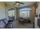 Functional home office with desk, comfortable seating, and access to outdoor space through sliding door at 11500 E Cochise Dr # 2088, Scottsdale, AZ 85259