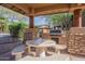Community outdoor grill and picnic area with stone accents and desert landscaping at 11500 E Cochise Dr # 2088, Scottsdale, AZ 85259