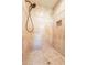 Close up of an open shower featuring tiled walls, a shower head and a niche at 11500 E Cochise Dr # 2088, Scottsdale, AZ 85259