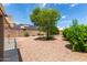 Spacious backyard featuring desert landscaping, solar panels on roof, and ample room for outdoor activities at 11520 W Lizard Ct, Surprise, AZ 85378