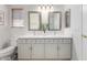 Bathroom with dual sinks, bright cabinets, mirrors and a toilet at 11520 W Lizard Ct, Surprise, AZ 85378
