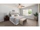 Bedroom with neutral color palette, ceiling fan, carpet and a window overlooking the front yard at 11520 W Lizard Ct, Surprise, AZ 85378