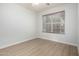 Neutral bedroom featuring a window providing natural light and laminate floors at 11520 W Lizard Ct, Surprise, AZ 85378