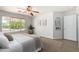 Bedroom with carpet, neutral color palette, ceiling fan and a window overlooking the back yard at 11520 W Lizard Ct, Surprise, AZ 85378