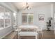 Bright dining room featuring a modern chandelier and lots of natural light from the windows at 11520 W Lizard Ct, Surprise, AZ 85378