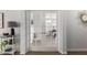 Bright hallway with french doors that lead to a bedroom with a neutral color palette at 11520 W Lizard Ct, Surprise, AZ 85378