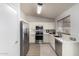 Modern kitchen with stainless steel appliances, white cabinets, and a functional layout at 11520 W Lizard Ct, Surprise, AZ 85378