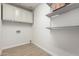Bright laundry room with built-in cabinets and shelving at 11520 W Lizard Ct, Surprise, AZ 85378