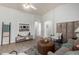 Elegant living room with neutral tones, wood flooring, and ample space for relaxation and entertainment at 11520 W Lizard Ct, Surprise, AZ 85378