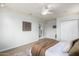 Bright main bedroom with ceiling fan, closet, and ensuite access through french doors at 11520 W Lizard Ct, Surprise, AZ 85378