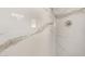 Shower featuring bright marble-patterned tile walls and stainless steel fixture at 11520 W Lizard Ct, Surprise, AZ 85378