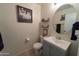Stylish bathroom featuring a round mirror and elegant decor, with a clean vanity and tasteful accents at 12161 W Flanagan St, Avondale, AZ 85323