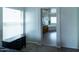 View from the bedroom into the bathroom featuring a soaking tub, cabinets and a window at 12161 W Flanagan St, Avondale, AZ 85323