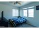 Comfortable bedroom featuring a ceiling fan and carpeted floor, with a bed and side table under a window at 12161 W Flanagan St, Avondale, AZ 85323