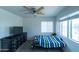This bedroom is equipped with a ceiling fan, ample lighting and contemporary furnishings at 12161 W Flanagan St, Avondale, AZ 85323