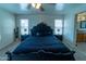 A spacious bedroom with a black headboard bed, bedside tables, and lots of natural light at 12161 W Flanagan St, Avondale, AZ 85323