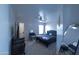Bedroom featuring a black tufted headboard, vanity, neutral carpet and natural light at 12161 W Flanagan St, Avondale, AZ 85323