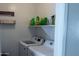 Laundry room featuring a side-by-side washer and dryer and shelving with laundry supplies at 12161 W Flanagan St, Avondale, AZ 85323