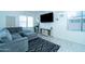 Cozy living room featuring a large gray sectional, decorative rug, and stylish entertainment center at 12161 W Flanagan St, Avondale, AZ 85323