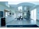 Bright open-concept living and dining area with modern decor and abundant natural light from multiple windows at 12161 W Flanagan St, Avondale, AZ 85323