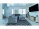 Comfortable living space with a large gray sectional, stylish rug, and entertainment center at 12161 W Flanagan St, Avondale, AZ 85323