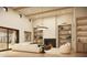 Inviting living room with a fireplace, built-in shelving, a comfortable sofa and a large sliding door to the outside at 13202 N 76Th Pl, Scottsdale, AZ 85260