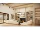 Bright living room features built-in shelves, modern fireplace, and view to the outdoor space at 13202 N 76Th Pl, Scottsdale, AZ 85260