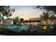 Beautiful backyard with a pool, spa, firepit and outdoor dining area set against a tranquil desert backdrop at sunset at 13202 N 76Th Pl, Scottsdale, AZ 85260