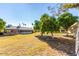 Wide backyard features mature citrus trees and views of the house at 13823 N 99Th Dr, Sun City, AZ 85351