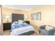 Cozy bedroom featuring a tufted headboard, side tables with lamps, and a serene ambiance at 13823 N 99Th Dr, Sun City, AZ 85351