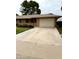Charming single-story home featuring a well-maintained lawn, mature tree, and an attached two-car garage at 13823 N 99Th Dr, Sun City, AZ 85351