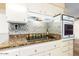 Well-lit kitchen with stainless steel appliances, granite countertops, and stylish tile backsplash at 13823 N 99Th Dr, Sun City, AZ 85351