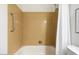 Bathroom with tiled tub and shower featuring a shower curtain and handle at 14401 N Boxwood Ln, Fountain Hills, AZ 85268