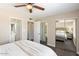 Serene bedroom featuring mirrored closet doors, a ceiling fan, and ensuite bathroom at 14401 N Boxwood Ln, Fountain Hills, AZ 85268