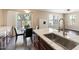 Modern kitchen with granite countertops, stainless steel sink, and dining area at 14401 N Boxwood Ln, Fountain Hills, AZ 85268