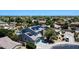 Stunning aerial view of a home with a pool and solar panels in a lush, green neighborhood at 14430 W Windsor Ave, Goodyear, AZ 85395