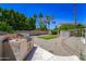 Landscaped backyard features a built-in grill, putting green, and plenty of space for outdoor recreation and relaxation at 14430 W Windsor Ave, Goodyear, AZ 85395