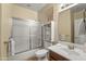 Clean bathroom with tiled shower, neutral walls, and a white vanity at 14430 W Windsor Ave, Goodyear, AZ 85395