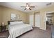 Open bedroom with ceiling fan and neutral design leads to more house space at 14430 W Windsor Ave, Goodyear, AZ 85395