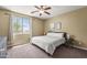 Neutral bedroom with carpet, ceiling fan, and large windows for great natural light at 14430 W Windsor Ave, Goodyear, AZ 85395