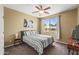 Bright bedroom with large window view and neutral tones, plus ceiling fan at 14430 W Windsor Ave, Goodyear, AZ 85395
