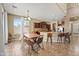 Inviting dining area with a wooden table, bench, and ample natural light at 14430 W Windsor Ave, Goodyear, AZ 85395