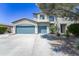 Charming two-story home featuring a three-car garage and drought-tolerant landscaping at 14430 W Windsor Ave, Goodyear, AZ 85395